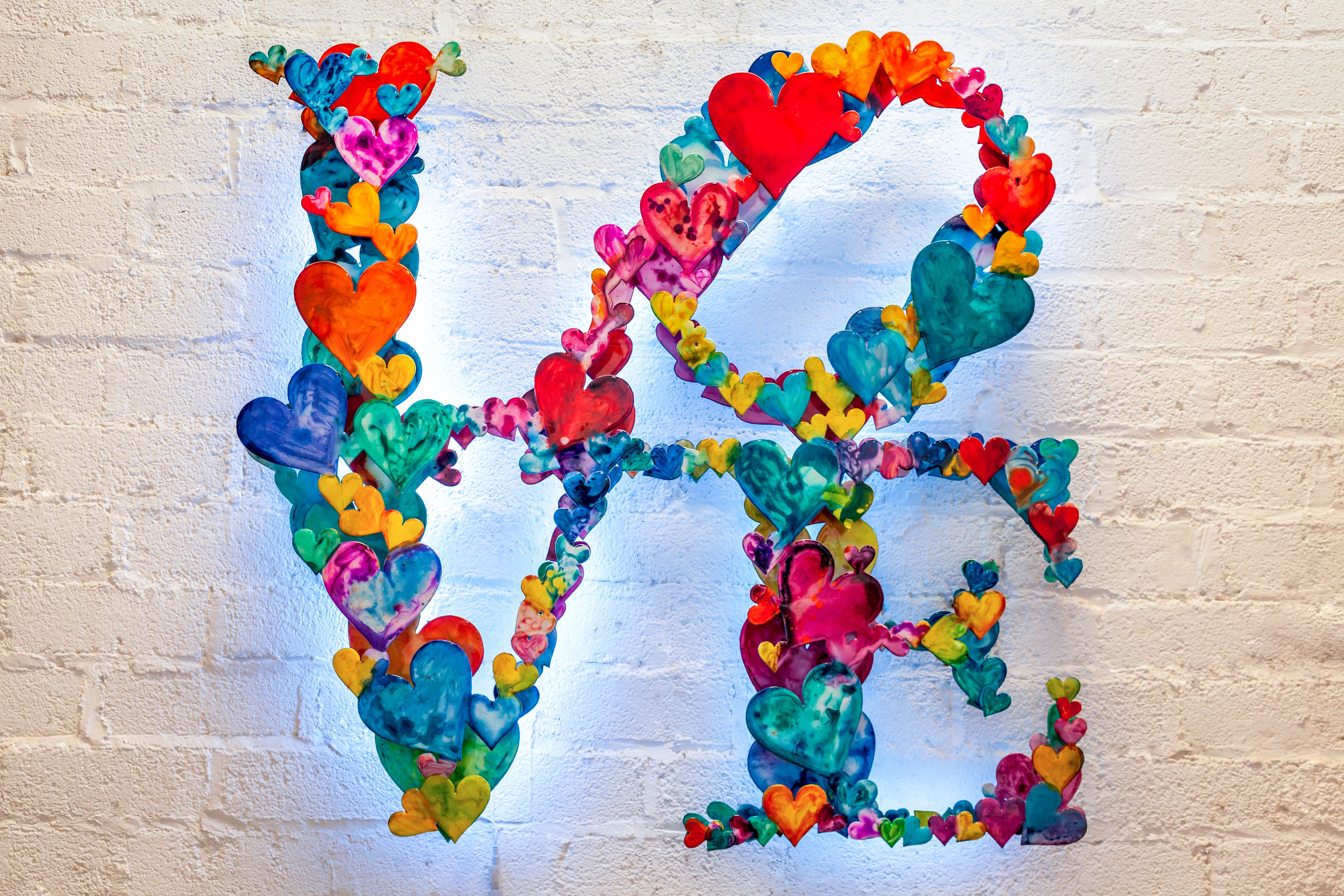 INFINITE LOVE canvas print in room setting - heart painting by Ivan Guaderrama